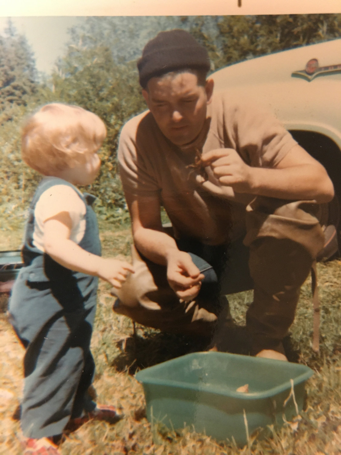 John Penberth, then working as a logger and tavern owner, shows his daughter a crawdad in 1968.